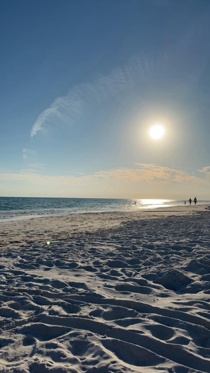 Late-afternoon sun melting into the Gulf shoreline